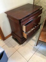 First mahogany end table showing the two open drawers and wood finish.