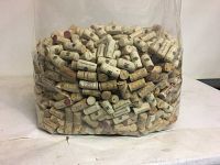 Large plastic bag filled with more than 1,000 used wine corks showing variety of stamps and markings on corks.