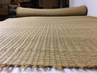 Photo showing close-up of woven straw matting texture with visible unbound edges.