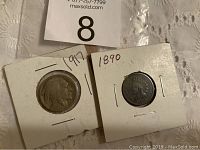 Two vintage U.S. coins in individual protective holders: 1917 Buffalo nickel and 1890 Indian Head penny, labeled with years on holders.