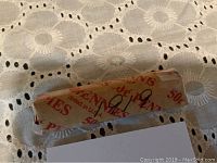 Top view of sealed roll of wheat pennies with handwritten year 1919 on wrapper.