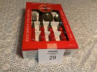 Full box showing unopened Coca-Cola flatware set with red handles inside original packaging.