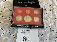 Full view of 1981 United States Proof Set in original packaging with six coins displayed against a red background and a black cover.