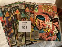 Front view of several Star Trek comic books showing colorful covers featuring main characters including Spock, with price points displayed.
