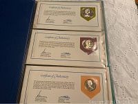 Certificates of Authenticity for three different First Day Covers with embedded coins.