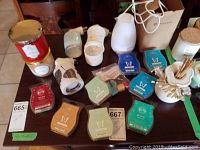 Lot contents overview showing candles, wax bars, plug-ins, diffuser, and flower diffuser