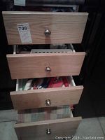 Wooden drawers with open view showing kitchen utensils and items inside