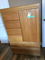 Front view of the tallboy dresser showing 4 smaller drawers on the left side and one door on the right