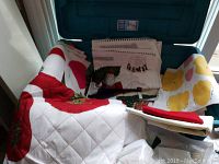 Bin of assorted fabrics including Christmas prints, flannelette, quilted and various patterned pieces