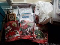 Photo of three boxed Christmas sock monkey kits named Rudy, Jingles, and Noel, each with holiday-themed packaging and illustrations.
