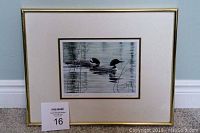 Framed print showing two loons in water surrounded by reeds, 11x14 inches, with gold-colored frame and white mat