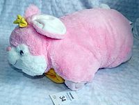 Side view of the pink plush Cozy Critters pillow animal with visible yellow blanket folded underneath