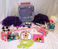 Overall photo showing entire toy set with camera, pom poms, jump rope, flashlights, and other items