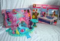 Photo showing two Barbie playsets side by side, boxed pool set and unboxed mermaid underwater set.