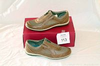 Side view of tan Naturalizer women's shoes on original red box showing zippered upper and textured finish.