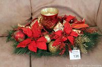 Full view of Christmas centerpiece with candle on beige fabric surface