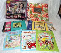 Photo showing all scrapbooking kits and albums arranged on a white surface.
