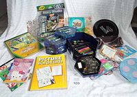 Overview photo showing a large lot of craft and art supplies including Star Wars Crayola Story Studio, puzzles, and art sets in blue cases.