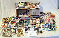 Wide view of scattered hockey trading cards from the 80s and 90s with some older cards, showing a variety of NHL teams and players.