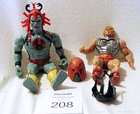 Two vintage Masters of the Universe action figures of He-Man (1991) and Skeletor (1985) with accessories, sitting side by side.