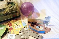 LivingWorld hamster cage with purple exercise ball and edible playhouse accessories laid out beside it