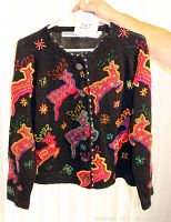 Front view of black Michael Simon cardigan with colorful beaded and embroidered reindeer and star patterns, showing full front button closure.