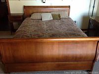 Front view of bed showing curved headboard and footboard