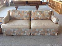 Front view of the multi-fabric Bo-Ho style couch showing patchwork and beige cushions