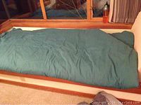 Blue air mattress fully inflated, shown on carpet near window