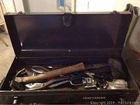 Image of open black Craftsman metal toolbox filled with assorted hand tools including hammer and scissors