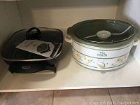 Rival Crock-Pot slow cooker and Betty Crocker electric frypan side by side on shelf