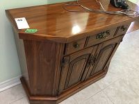 Front view of the wood hall table showing drawer, doors, and hardware.