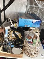 Lot viewed from above showing baskets, boxed foot bubbler, picture frames, and small items