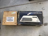 Original box for Texas Instruments Home Computer 99/4A and a secondary cardboard box marked with accessory information.