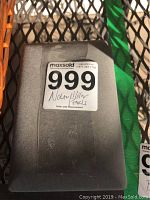 Gray presentation box closed with handwritten sticker indicating 'Nolan Miller Pearls' and lot number