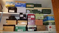 Stack of various women’s shoe boxes on shelving