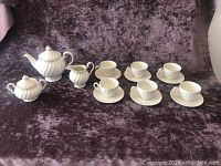 Full set of Johnson Brothers white ironstone tea set items displayed on purple velvet background.