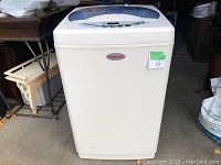 Front view showing compact white washer/dryer with HomeComfort branding and top-loading lid.