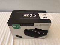 Front view of the ex3D VR goggles box showing brand and key features including 360° video and gaming capability through virtual reality, and Bluetooth gaming remote included.