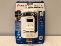 Front view of new Kidde 3-in-1 carbon monoxide, propane, and natural gas detector in original packaging with Energizer battery included