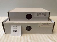 Two stacked white boxes showing labels for Kristina 7x7 and Kristina 8x10-20 burgundy photo albums.