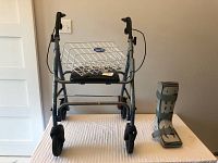 Picture of Free Spirit walker with attached EZee Life basket from front view, showing adjustable handles and wheels.