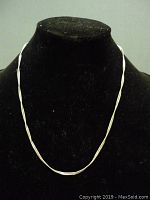 Full view of the silver chain necklace displayed on a black velvet stand showing length and overall form.