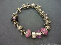 Full view of the bracelet showing the chain, glass charms and spacer beads