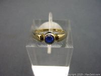Front view of the 10K gold ring showcasing the round blue cabochon stone in bezel setting.