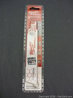 Full view of Milwaukee Sawzall 5 metal blades in original sealed packaging with branding and blade markings visible.