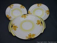 Top-down view of the round scone serving tray with handles, yellow Laburnum floral pattern with leaves, subtle yellow gradient at center