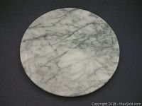 Top view of the round marble lazy Susan showing natural veining and some surface imperfections.