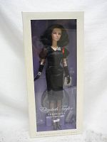 Front view of the Elizabeth Taylor Barbie Doll in original box, showing the doll dressed in black with accessories visible through the clear window.