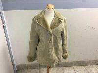 Front view of vintage ladies leather jacket on mannequin, showing button front and fur collar, cuffs.